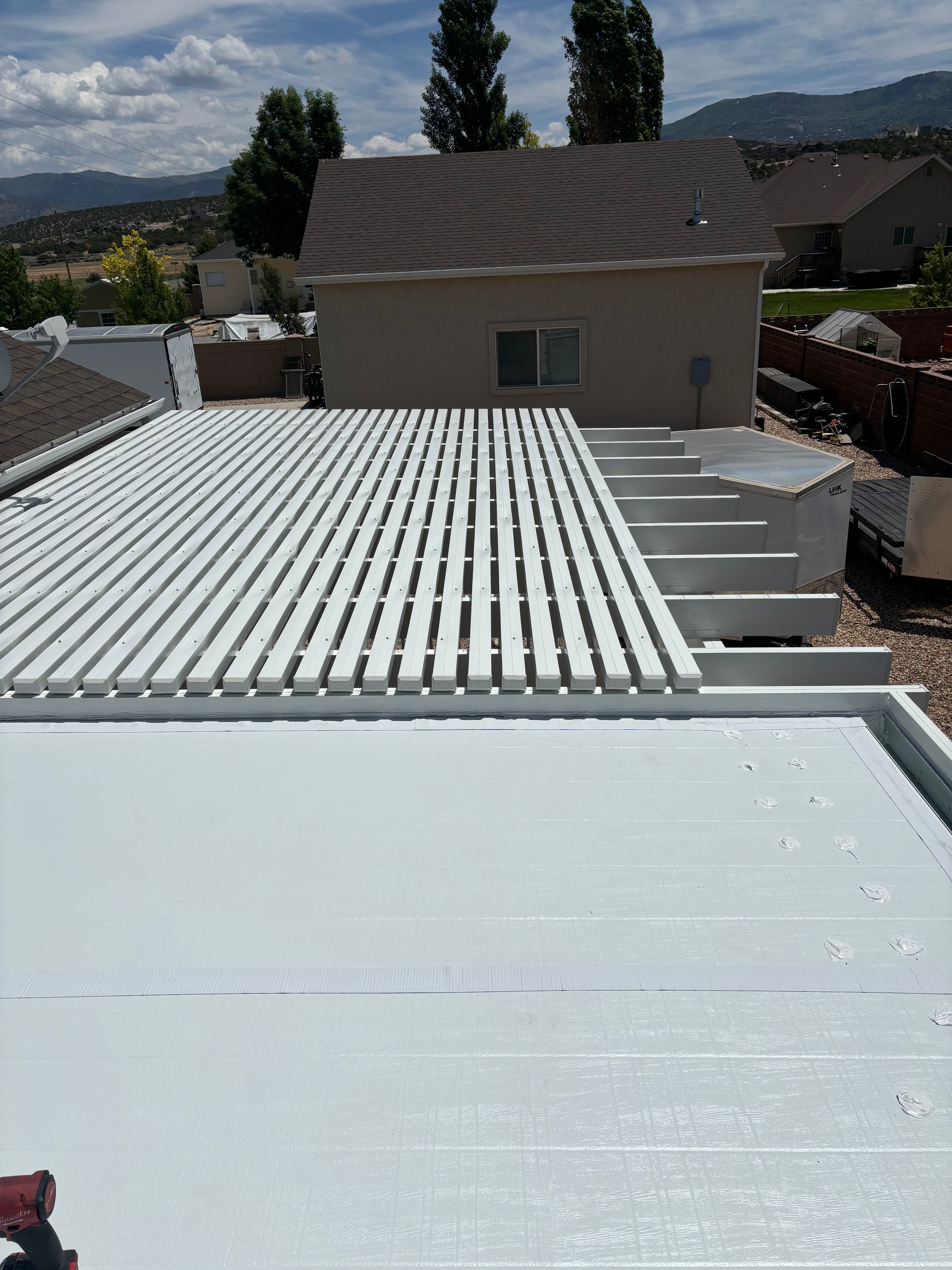 Solid patio cover providing full shade over an outdoor lounge